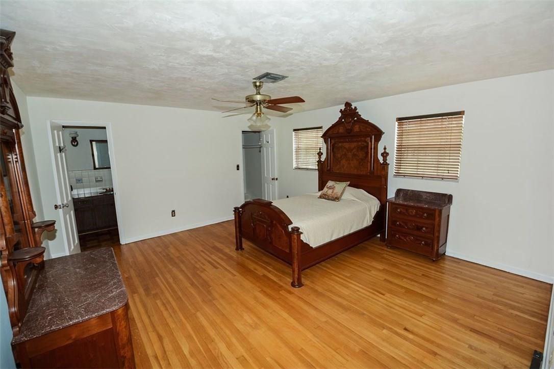13851 Stirling Road Southwest Ranches, FL 33330 - Photo 17 of 33 a bedroom with a bed and a flat tv screen on a dresser