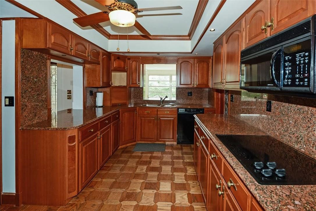 13851 Stirling Road Southwest Ranches, FL 33330 - Photo 23 of 33 a kitchen with stainless steel appliances granite countertop a sink stove and cabinets
