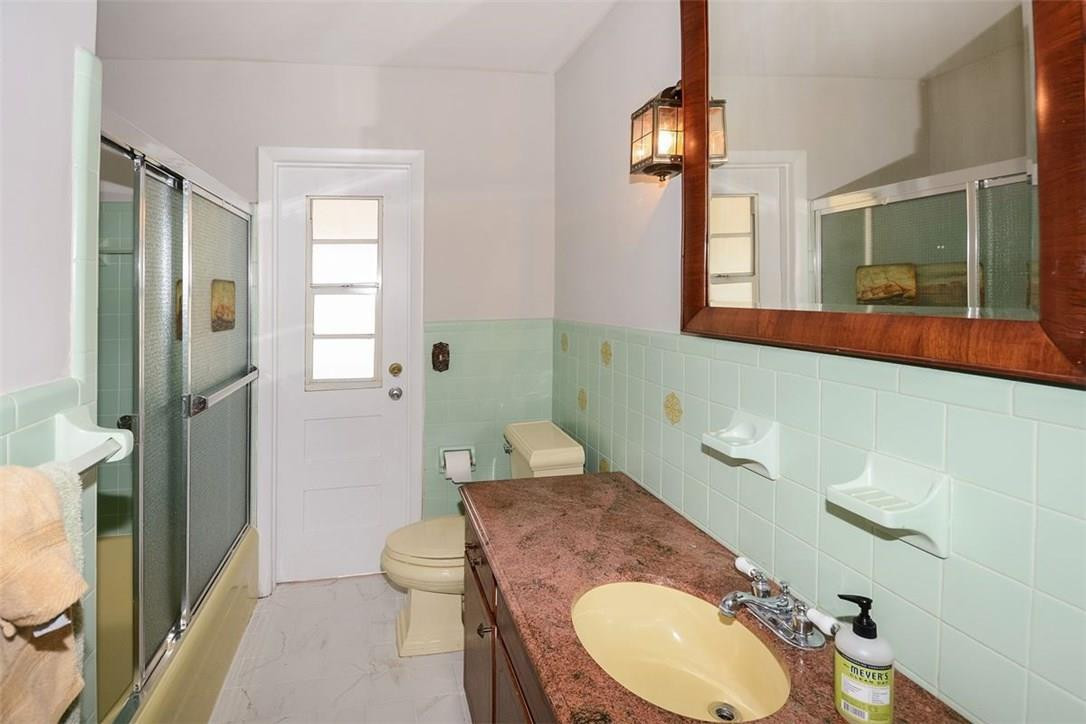 13851 Stirling Road Southwest Ranches, FL 33330 - Photo 30 of 33 a en suite bathroom with a granite countertop toilet sink and mirror