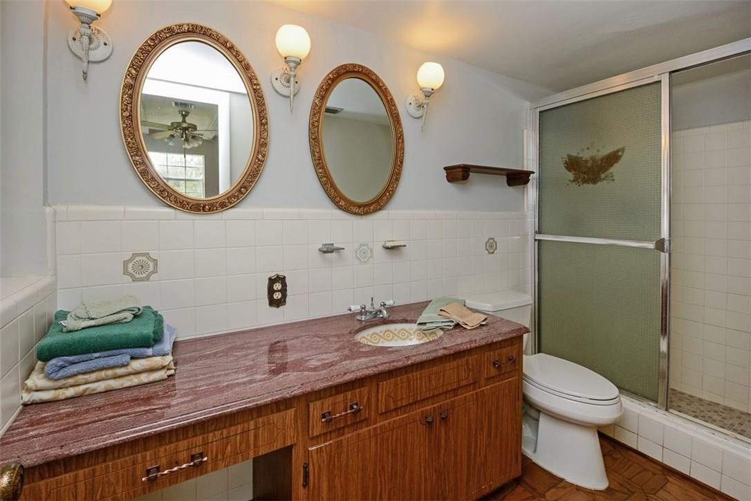 13851 Stirling Road Southwest Ranches, FL 33330 - Photo 33 of 33 a bathroom with a granite countertop toilet a sink and a mirror