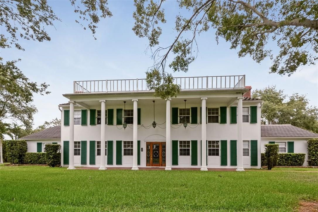 13851 Stirling Road Southwest Ranches, FL 33330 - Photo 5 of 33 a front view of a house with a garden