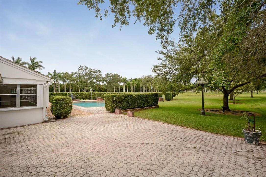 13851 Stirling Road Southwest Ranches, FL 33330 - Photo 8 of 33 a view of a house with backyard and garden