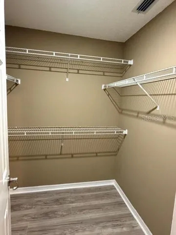 a bathroom with a granite countertop sink mirror vanity and toilet
