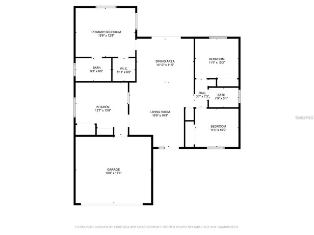 a view of a backyard with plants and large tree