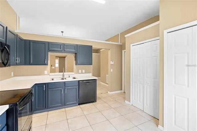 a kitchen with a sink a stove a microwave and cabinets