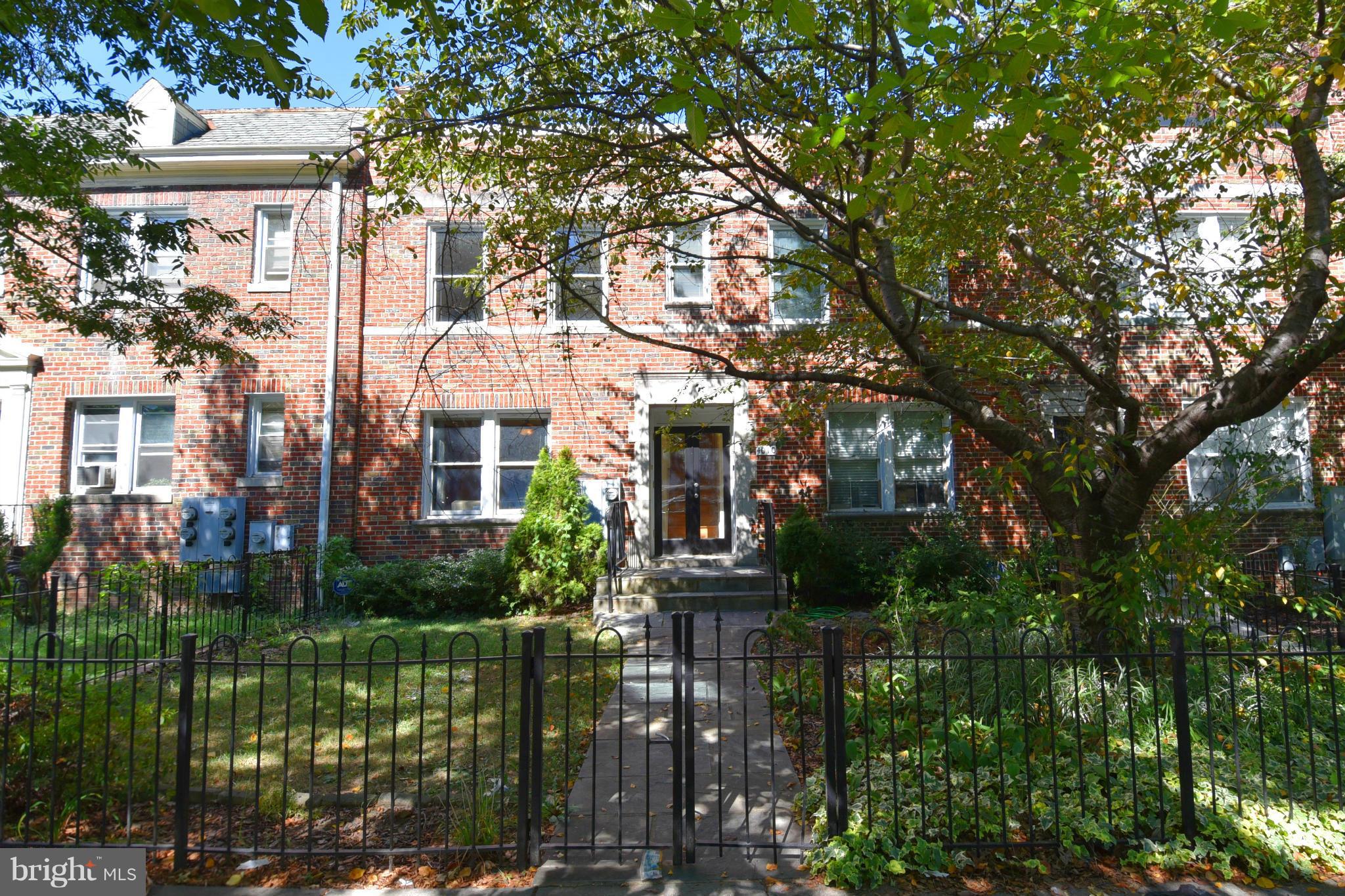 4010 Kansas Avenue Northwest, Unit 1 Washington, DC 20011 - Photo 2 of 28 a front view of a house with a garden