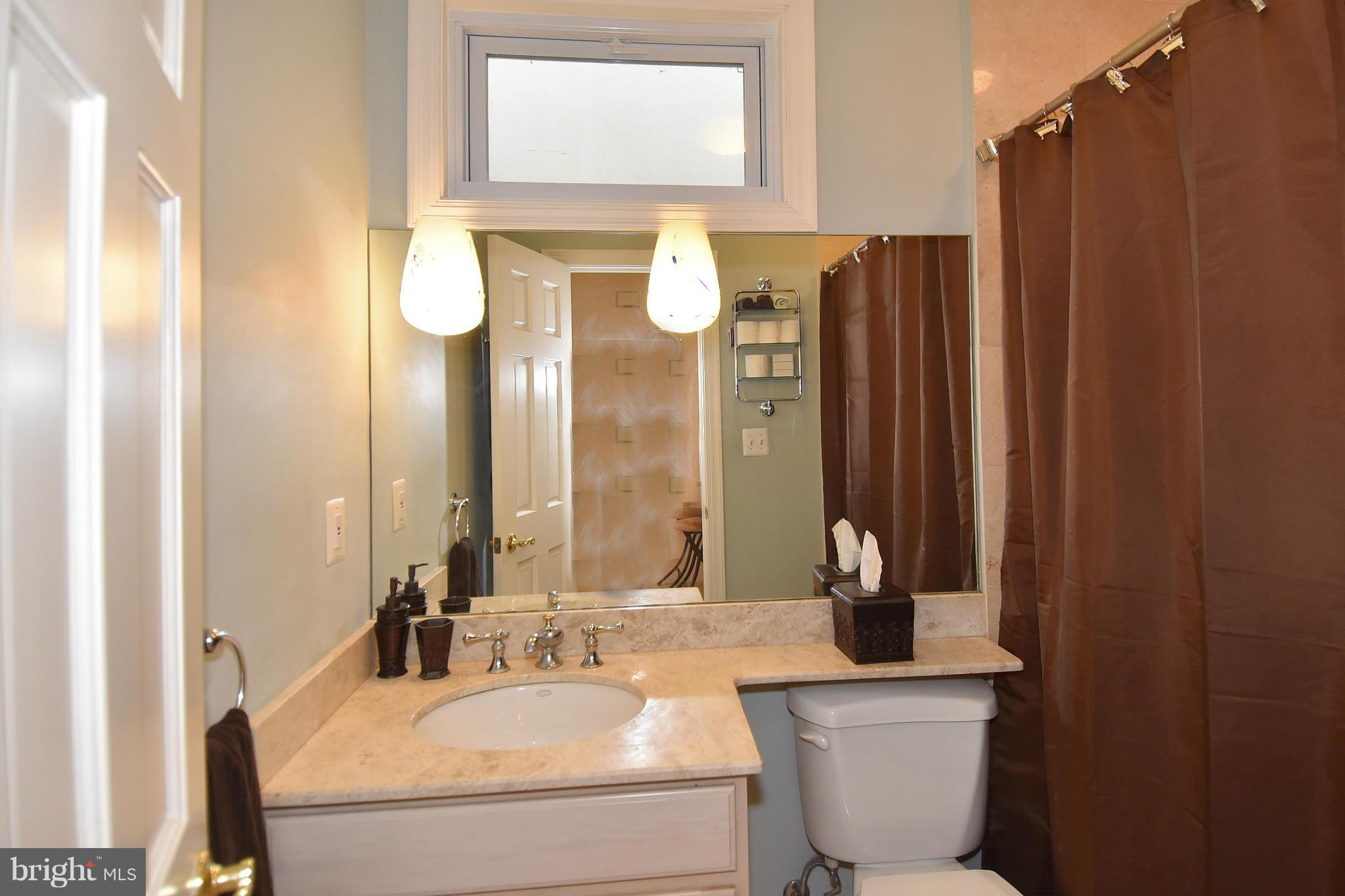 4010 Kansas Avenue Northwest, Unit 1 Washington, DC 20011 - Photo 12 of 28 a bathroom with a sink and a mirror