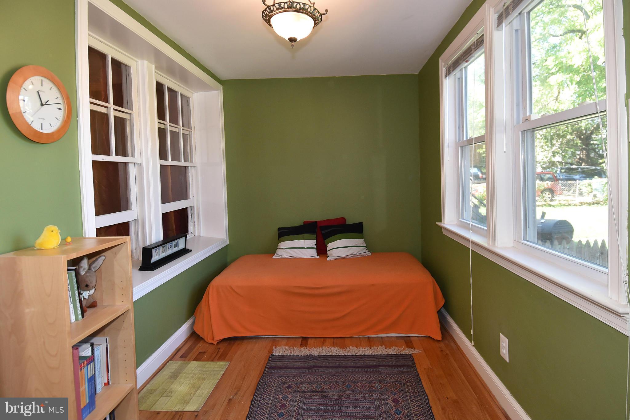 4010 Kansas Avenue Northwest, Unit 1 Washington, DC 20011 - Photo 13 of 28 a bed sitting in a bedroom next to a window