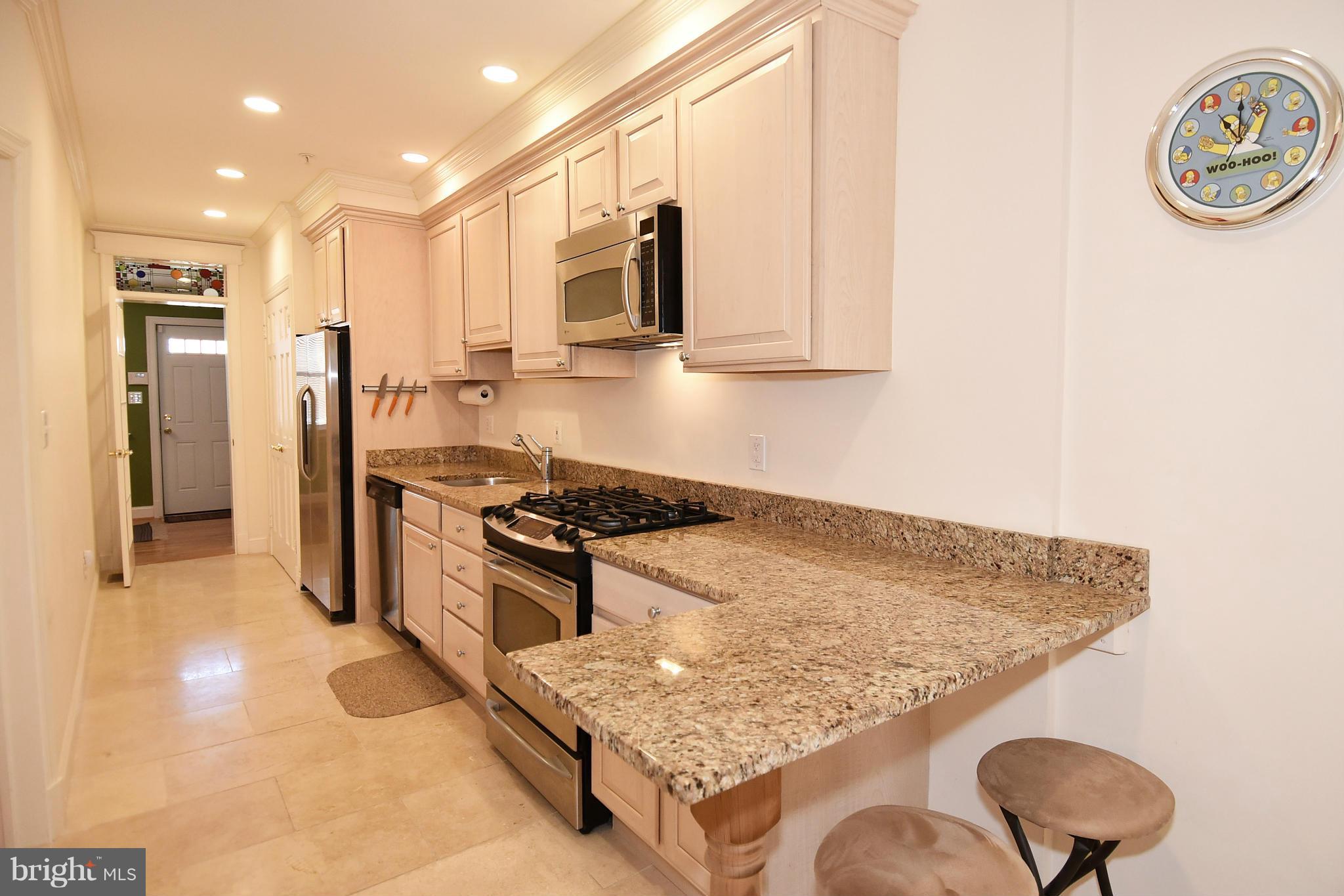4010 Kansas Avenue Northwest, Unit 1 Washington, DC 20011 - Photo 7 of 28 a kitchen with stainless steel appliances granite countertop a sink stove and refrigerator