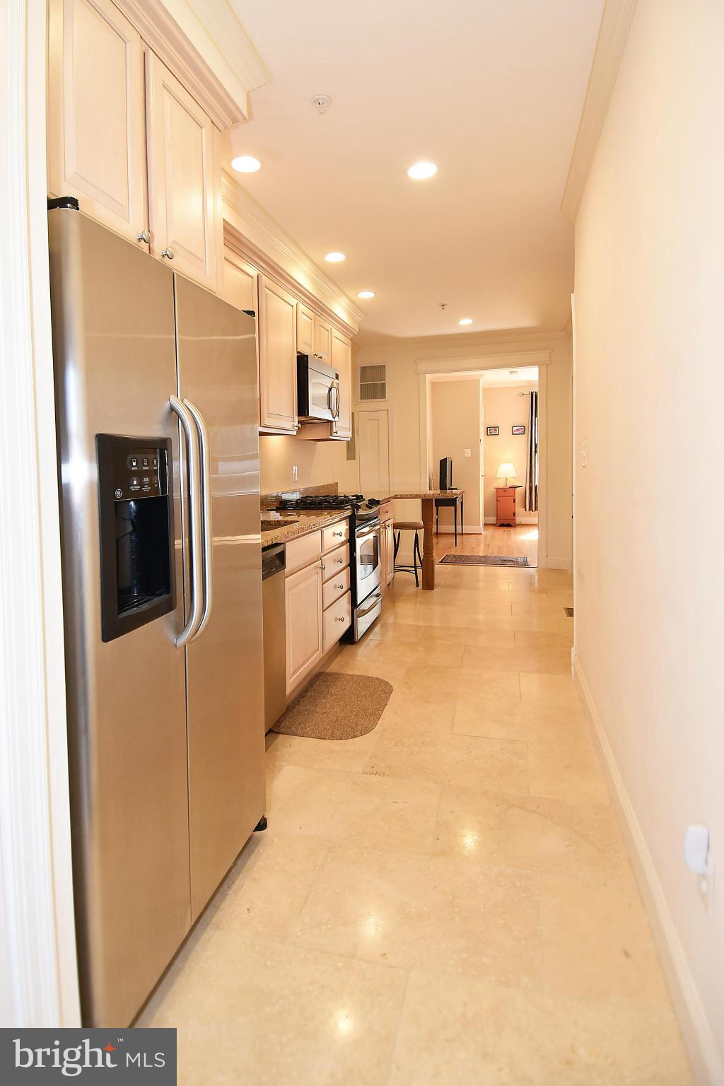 4010 Kansas Avenue Northwest, Unit 1 Washington, DC 20011 - Photo 9 of 28 a kitchen with stainless steel appliances granite countertop a refrigerator and a stove top oven