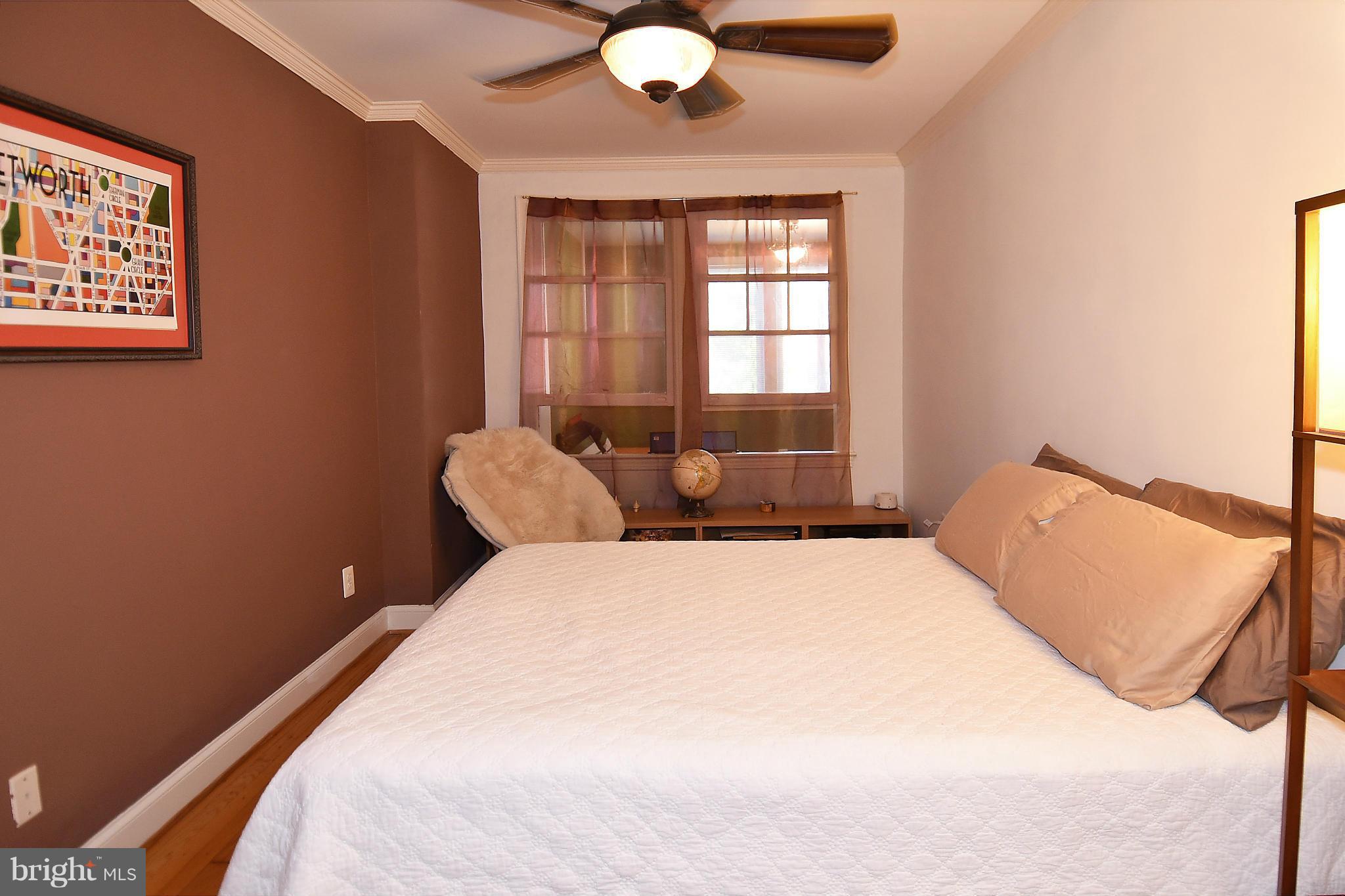 4010 Kansas Avenue Northwest, Unit 1 Washington, DC 20011 - Photo 10 of 28 a bedroom with a bed and window