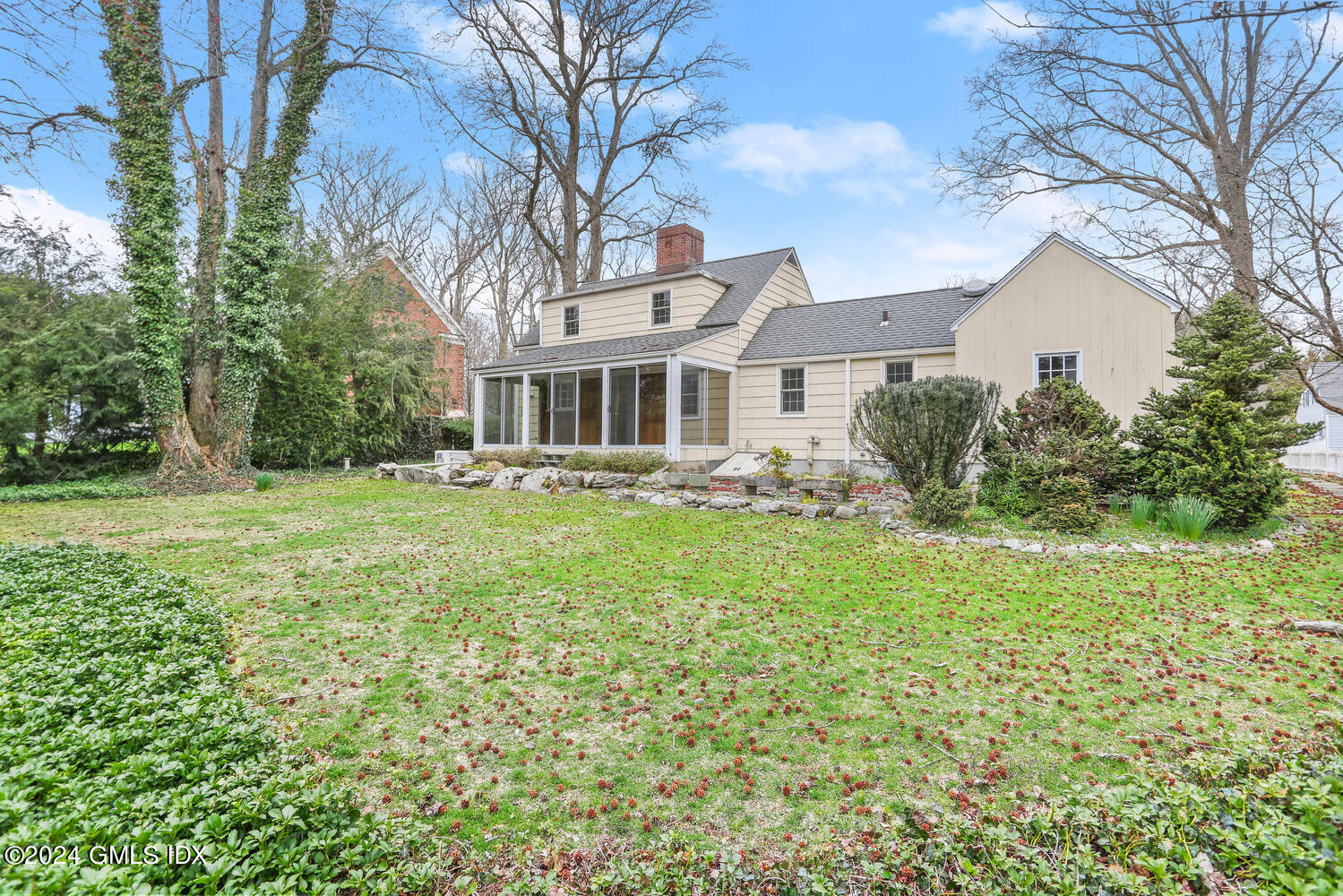 11 Field Road Riverside, CT 06878 - Photo 3 of 14 a front view of a house with garden