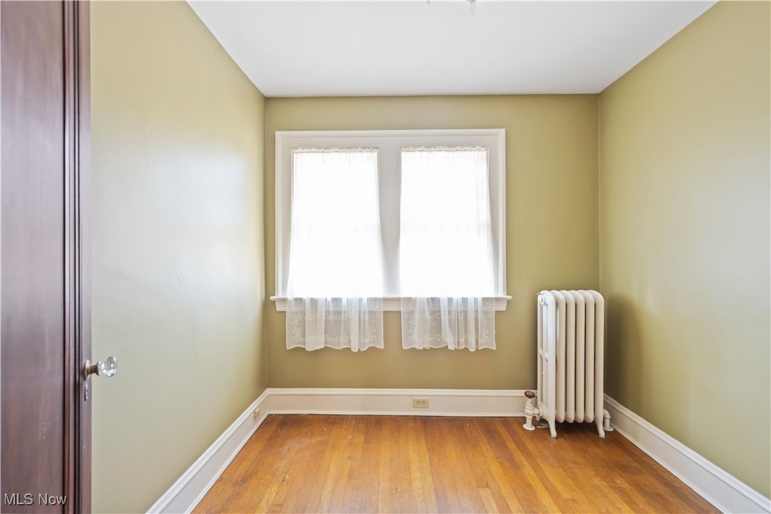 24510 Lake Road Bay Village, OH 44140 - Photo 39 of 45 Unfurnished room featuring radiator and hardwood / wood-style floors