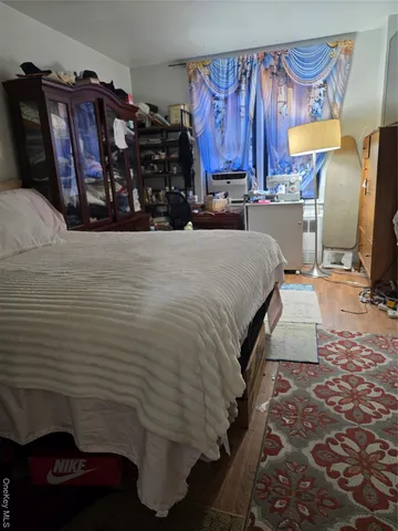 a bed room with a bed and a chair