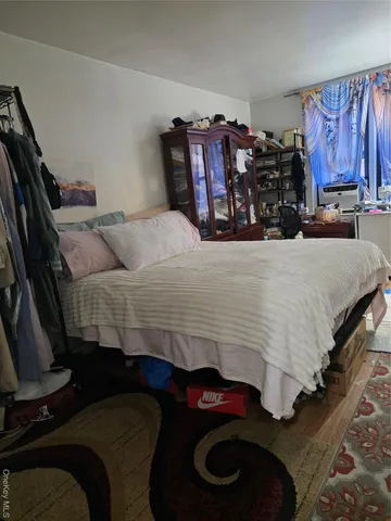 a bed sitting in a bedroom next to a lamp