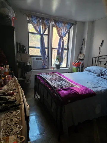a bedroom with bed and a window