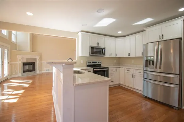 a kitchen with a refrigerator a stove top oven a sink and dishwasher