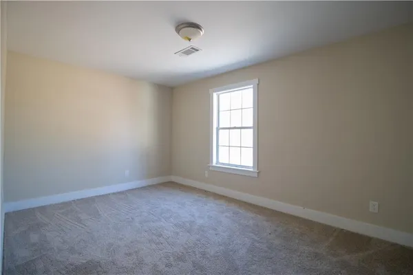 an empty room with a empty space and windows