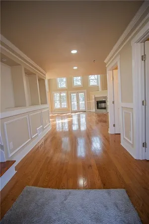 a view of empty room with wooden floor