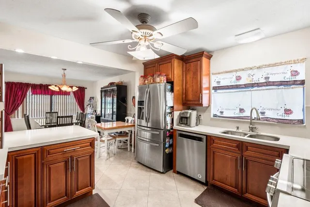 a kitchen that has a lot of cabinets in it and stainless steel appliances