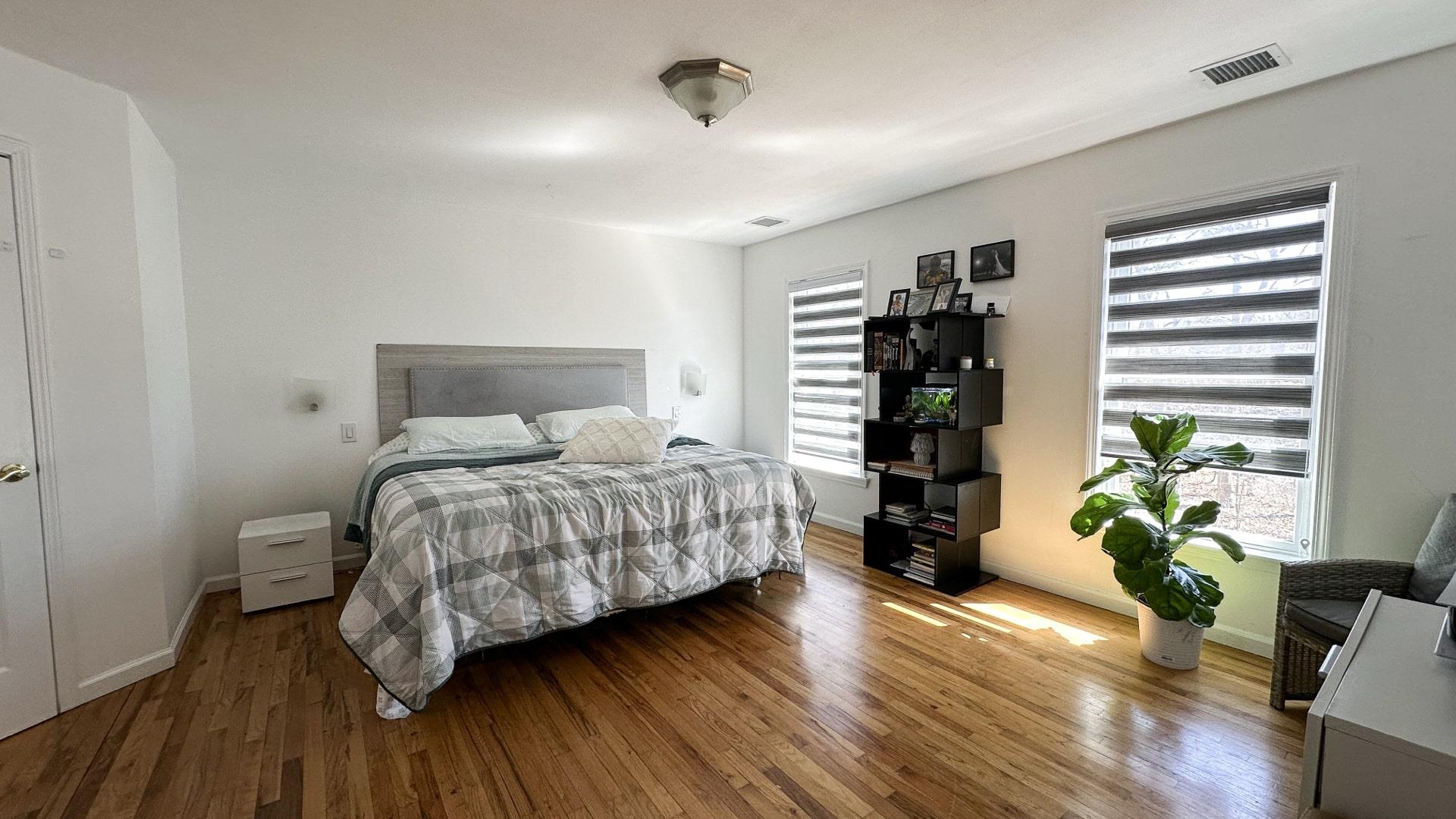 39 Washington Avenue East Hampton, NY 11937 - Photo 14 of 21 Bedroom featuring multiple windows, visible vents, wood finished floors, and baseboards