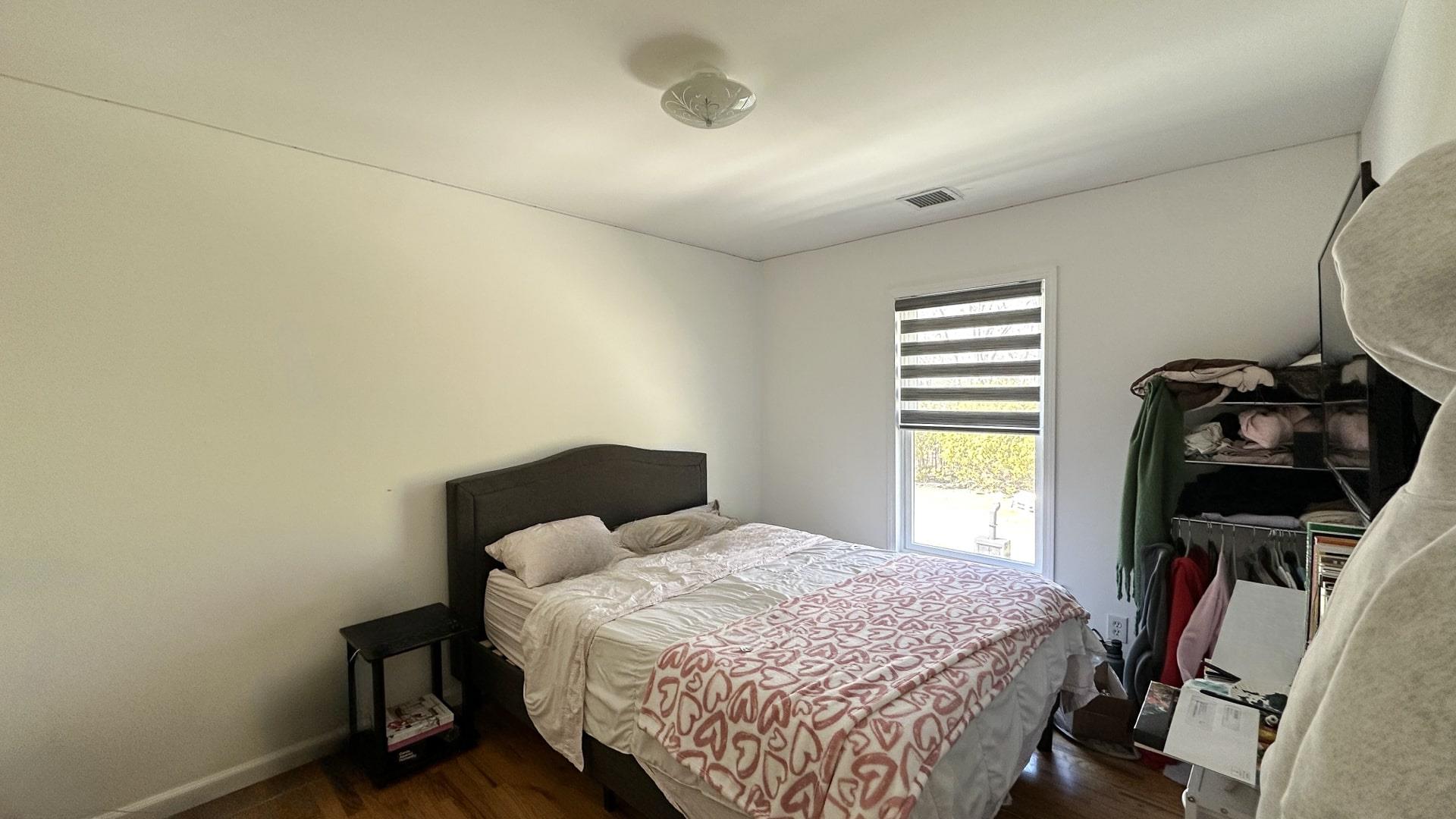 39 Washington Avenue East Hampton, NY 11937 - Photo 19 of 21 Bedroom with dark wood-type flooring, baseboards, and visible vents