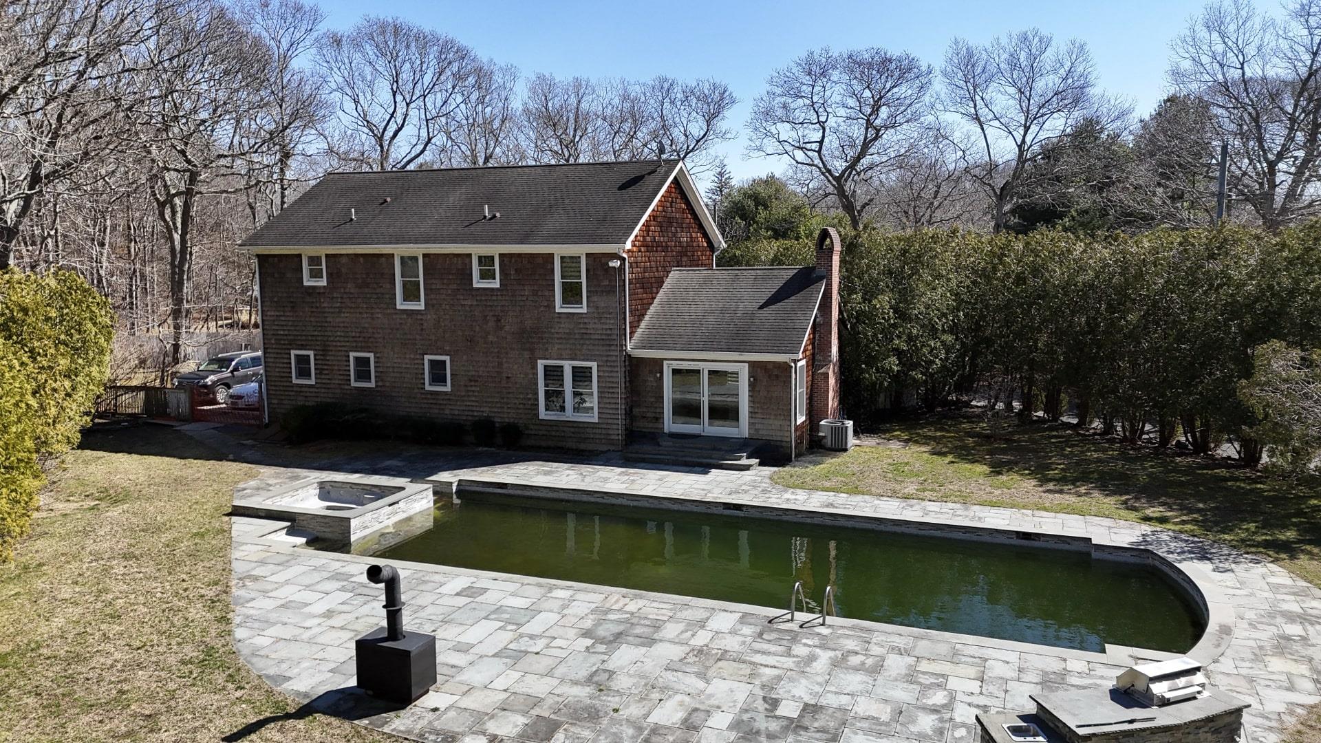 39 Washington Avenue East Hampton, NY 11937 - Photo 6 of 21 Back of house featuring a yard, entry steps, a patio area, and roof with shingles
