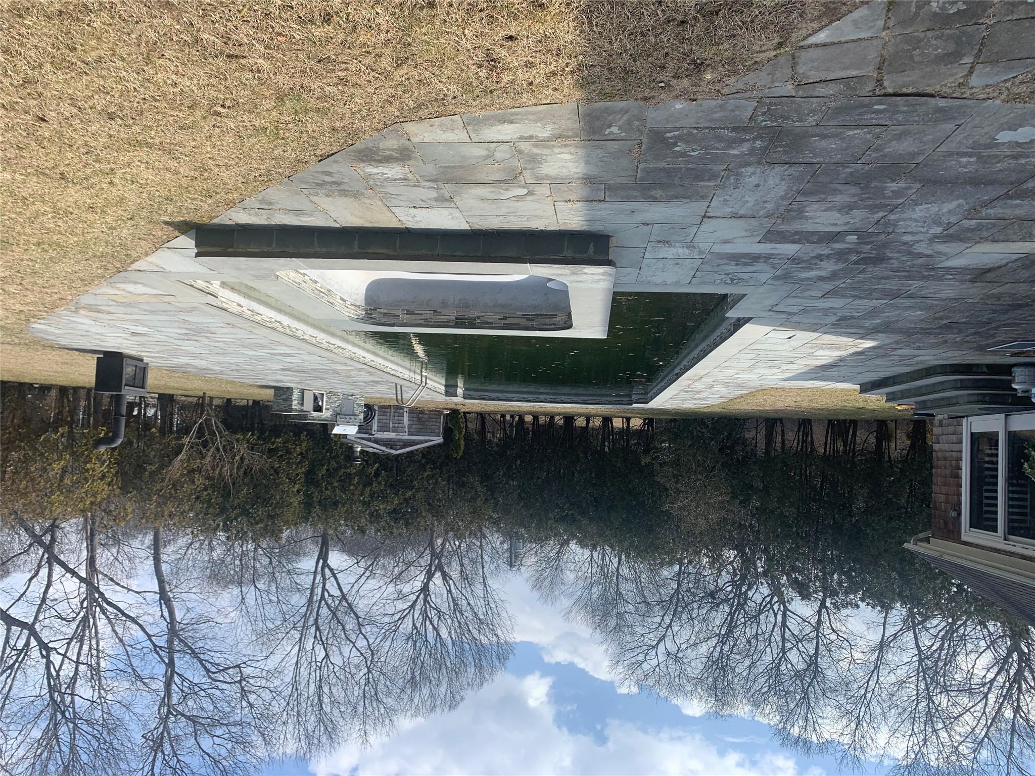 39 Washington Avenue East Hampton, NY 11937 - Photo 7 of 21 Outdoor pool with a patio area, entry steps, and an outdoor structure