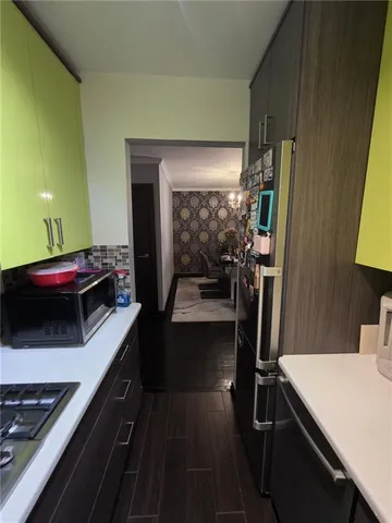 a view of a hallway with workspace and closet