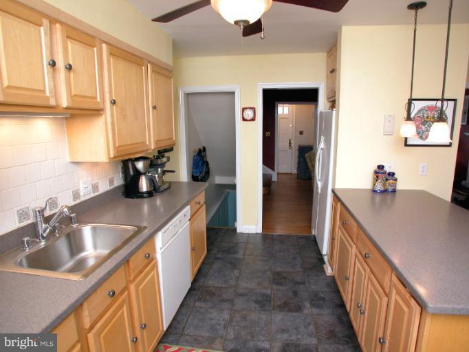 222 Gaywood Road Baltimore, MD 21212 - Photo 10 of 24 a kitchen with granite countertop a sink stove and cabinets