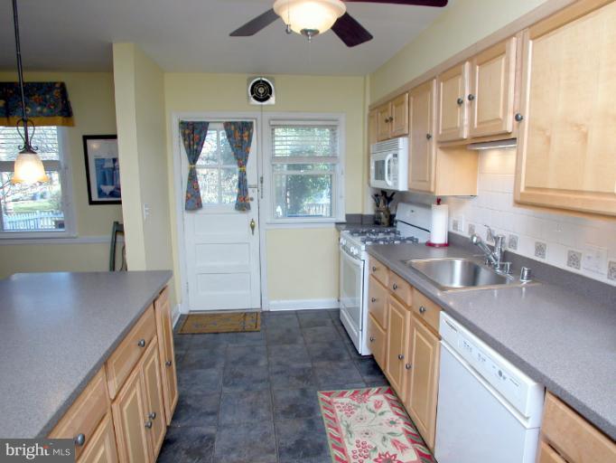 222 Gaywood Road Baltimore, MD 21212 - Photo 13 of 24 a kitchen with stainless steel appliances granite countertop a sink stove and cabinets