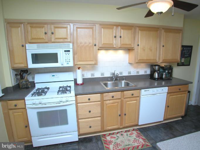222 Gaywood Road Baltimore, MD 21212 - Photo 15 of 24 a kitchen with cabinets appliances a sink and a counter