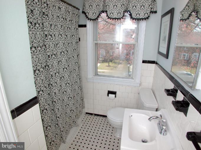 222 Gaywood Road Baltimore, MD 21212 - Photo 19 of 24 a bathroom with a sink and a shower curtain