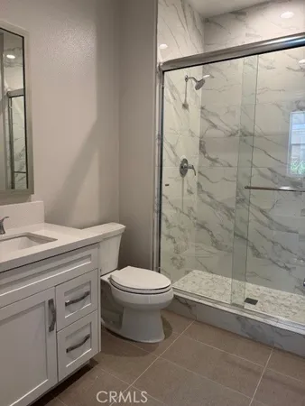 a bathroom with a shower a toilet and sink