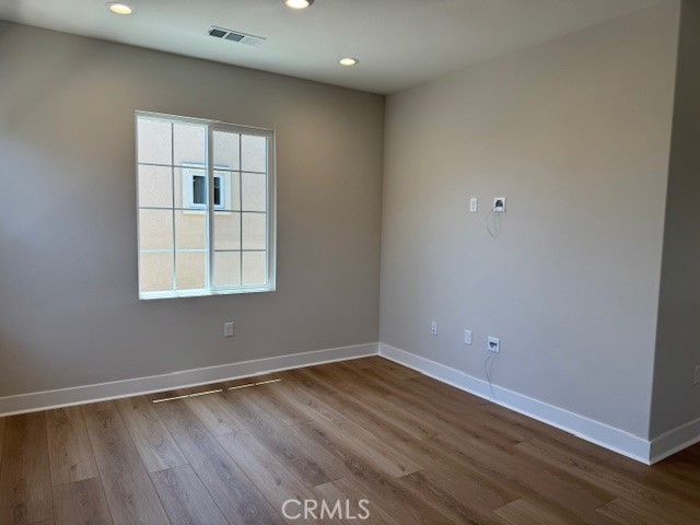 581 Patten Avenue Placentia, CA 92870 - Photo 14 of 23 an empty room with wooden floor and windows