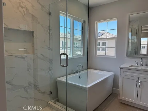 a white bath tub sitting in a bathroom next to a window