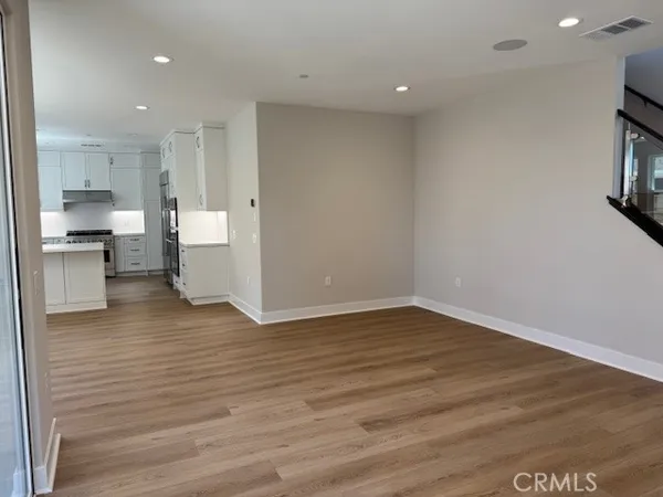 a view of kitchen with stove and cabinets
