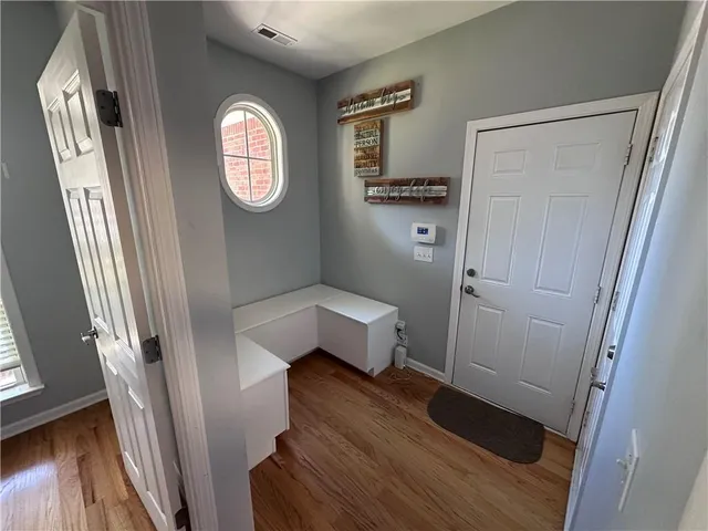 a view of an entryway with wooden floor
