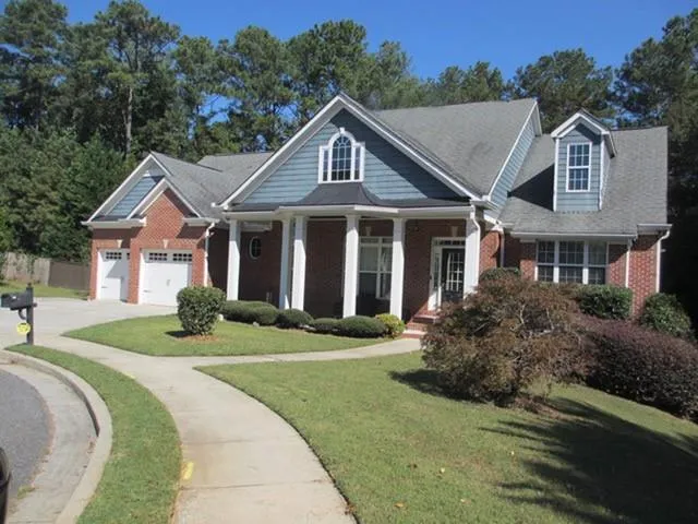 a front view of a house with a yard