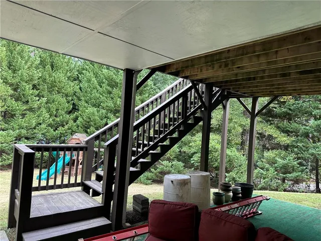 a view of porch with green trees
