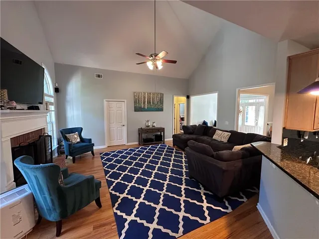 a living room with furniture a fireplace and a flat screen tv
