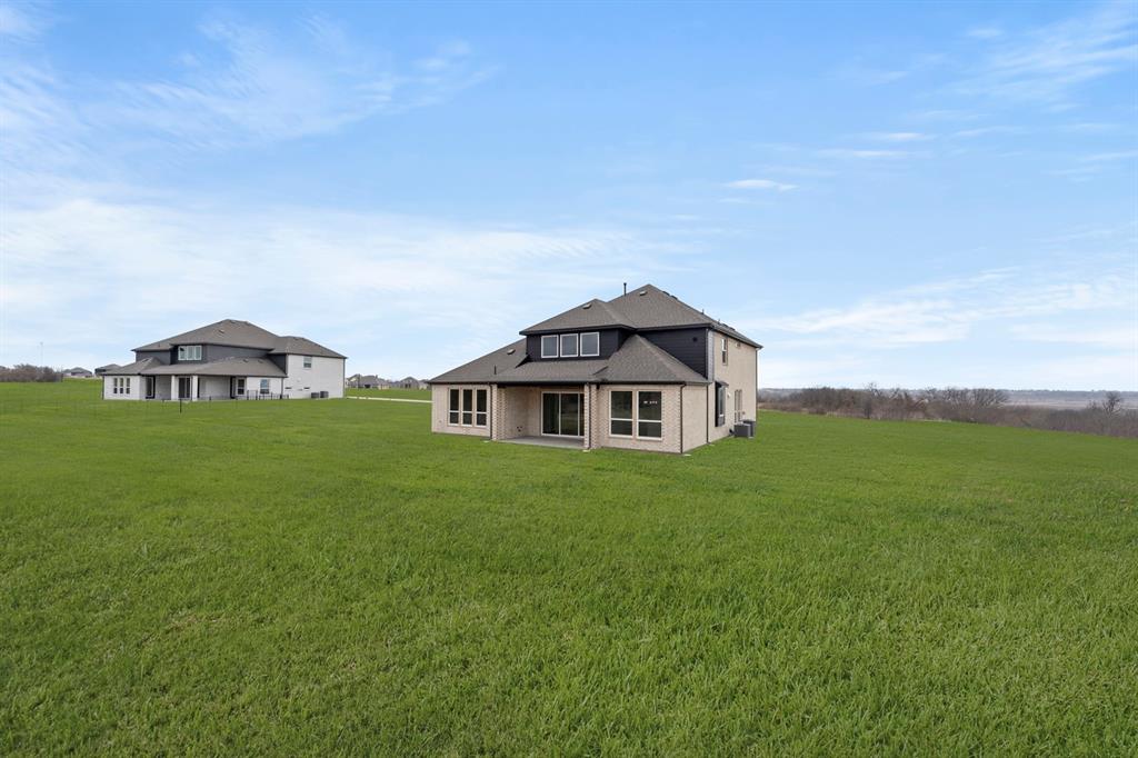 9916 Polo Pitch Lane Forney, TX 75126 - Photo 27 of 27 a view of a house with a big yard
