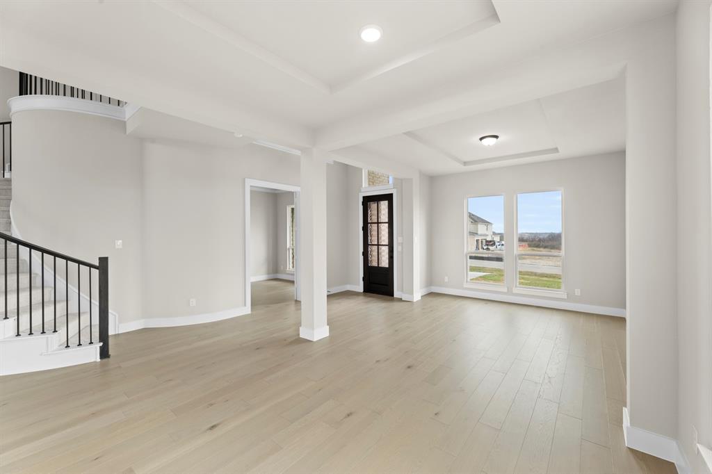 9916 Polo Pitch Lane Forney, TX 75126 - Photo 7 of 27 a view of an empty room with a window and wooden floor