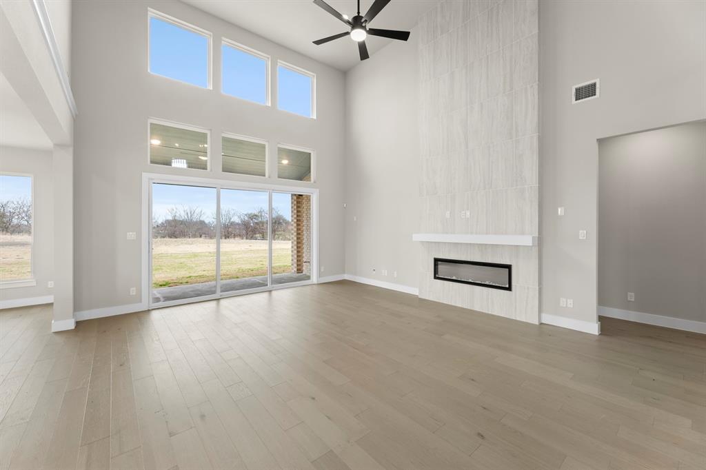 9916 Polo Pitch Lane Forney, TX 75126 - Photo 9 of 27 an empty room with wooden floor and windows