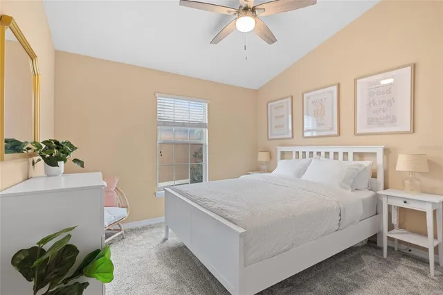 a bedroom with a bed and a potted plant