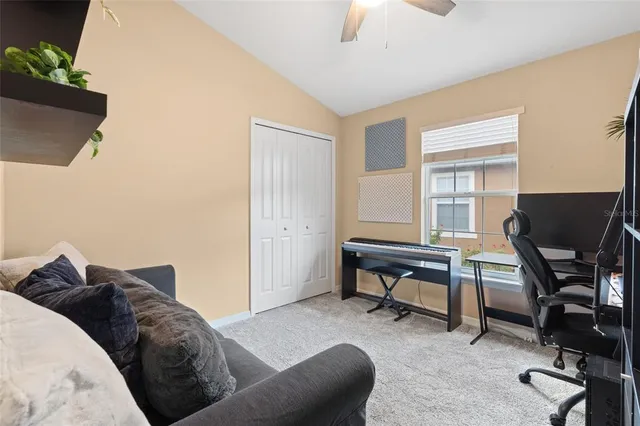 a livingroom with workspace and a window