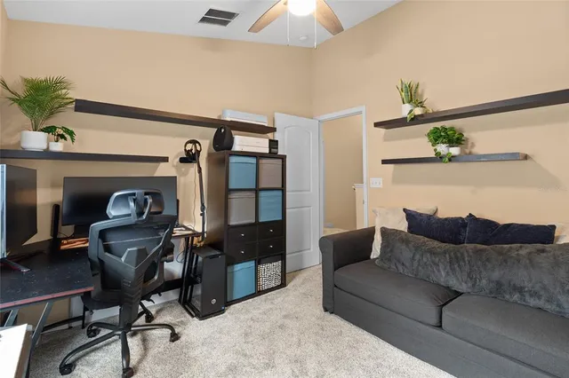 a living room with furniture and a piano