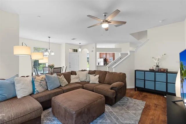 a living room with furniture and a chandelier