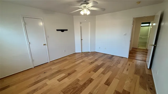 a white toilet sitting next to a window in a bathroom