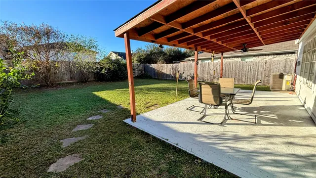 a view of a house with backyard and sitting area